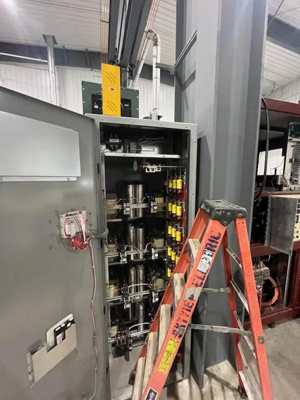 Electrical team working on capacitor-bank equipment