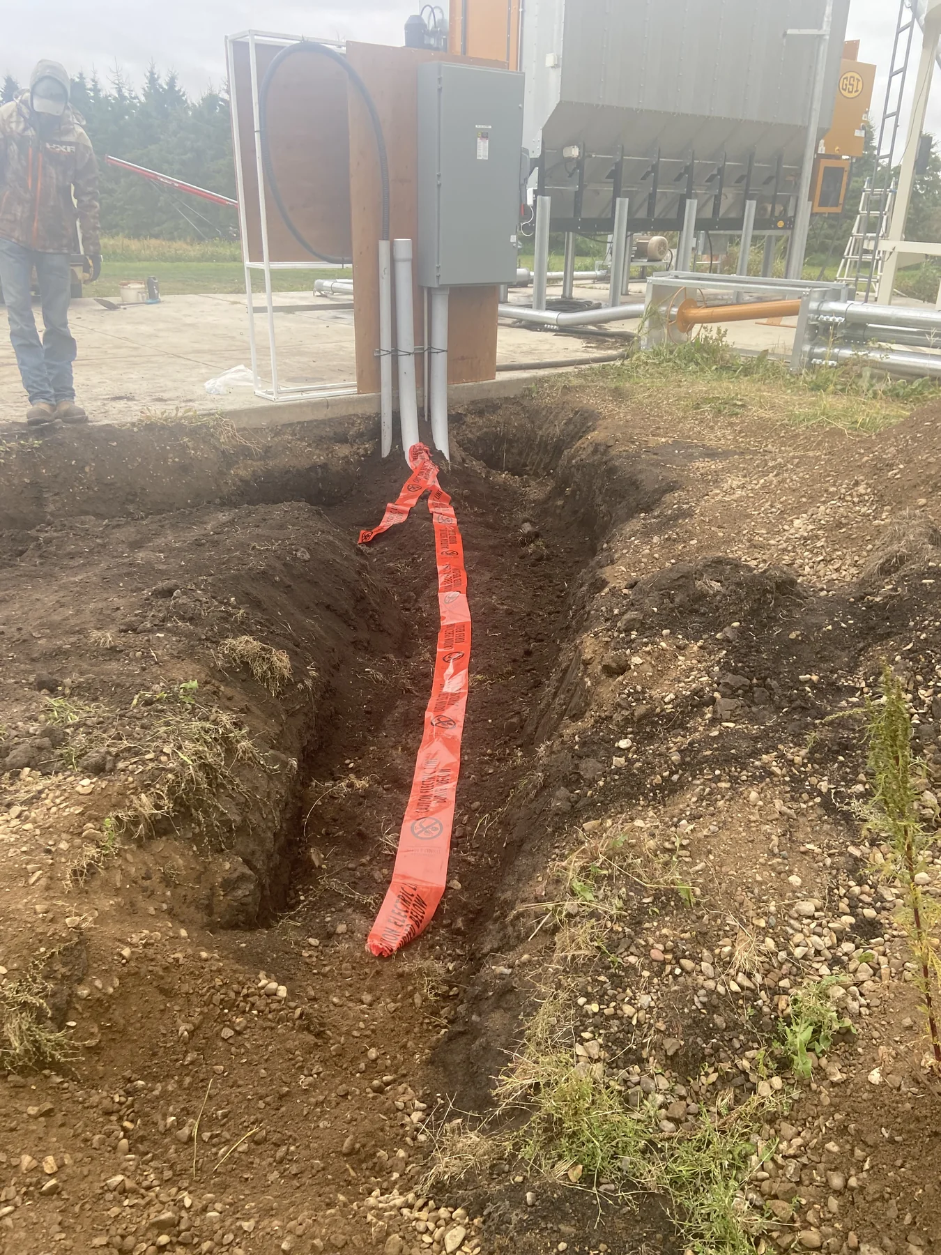 Prepared electrical trench leading to agricultural distribution equipment