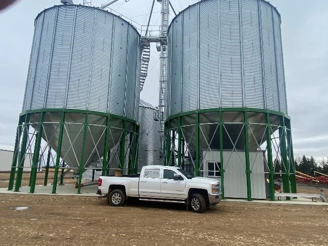Electrical equipment installed beside a grain dryer and storage bins
