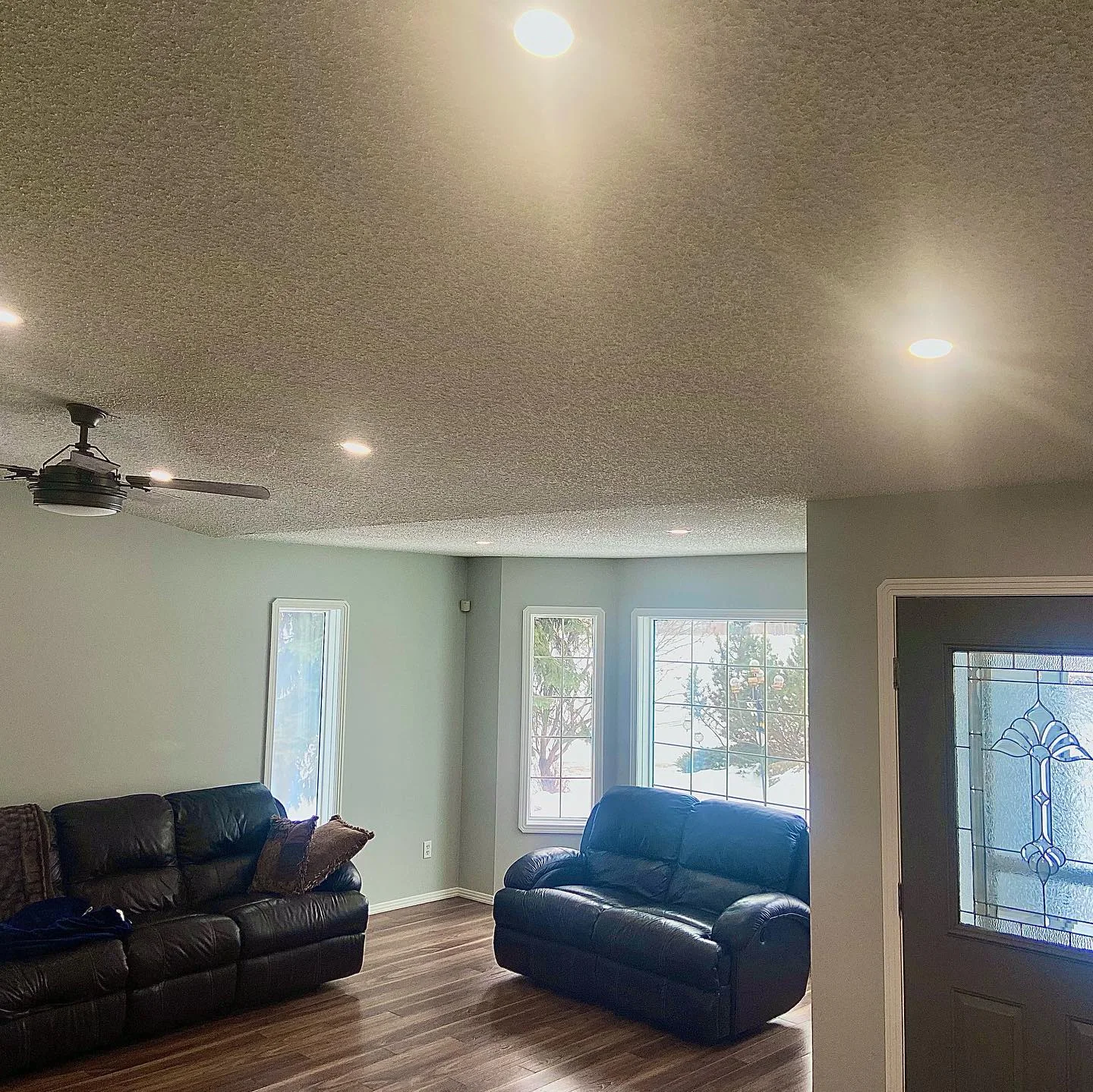 Finished living room with evenly spaced recessed lights